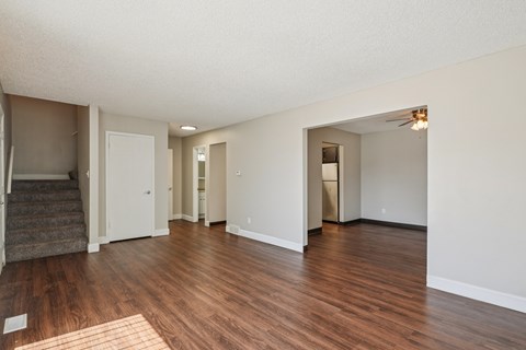 A room with wooden floors and white walls.